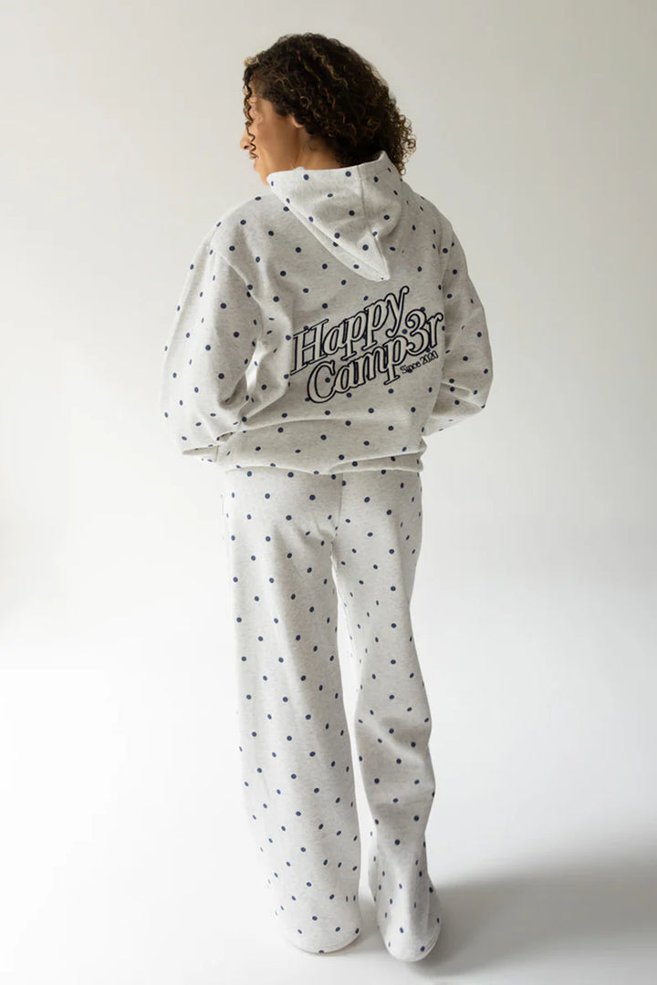 Person wearing a polka dot hoodie and pants with &