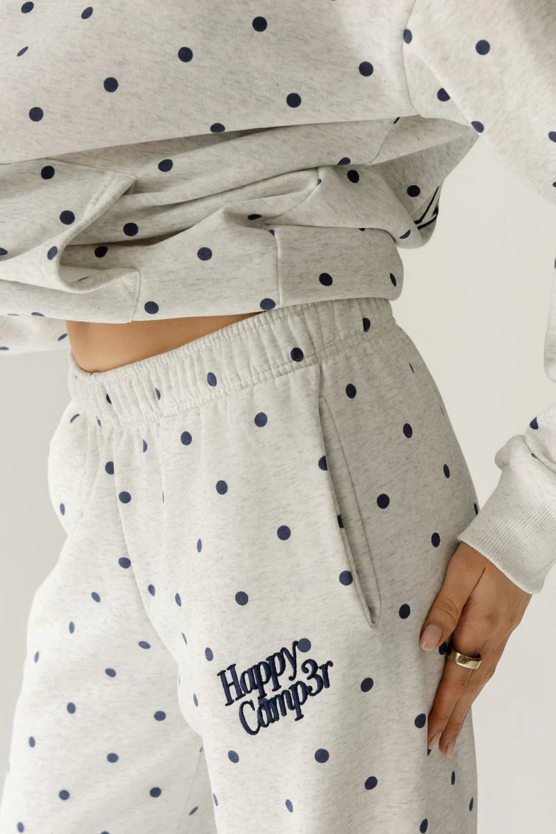 Gray sweatshirt with navy polka dots and matching pants with 'Happy Camper' text on a neutral background