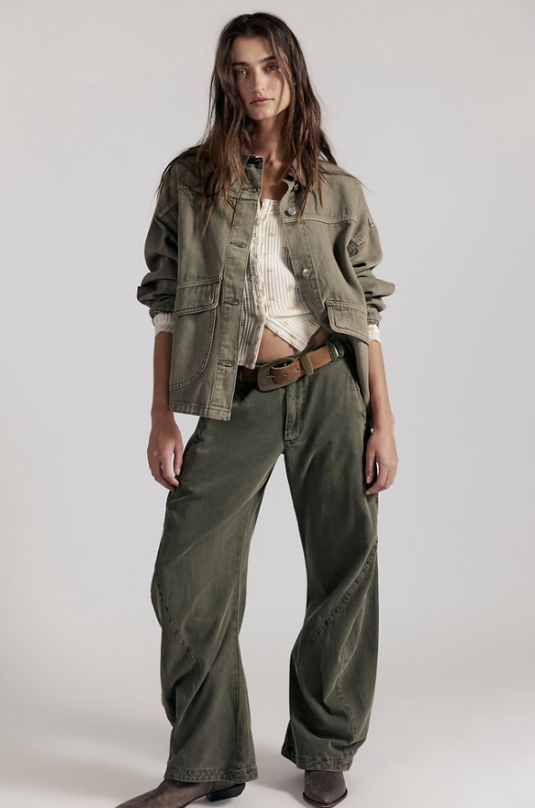Woman wearing green pants and jacket on white background