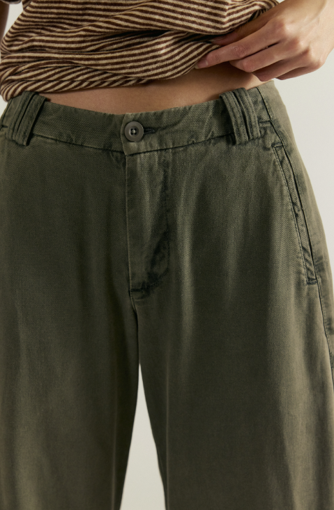 Close up of green pants and stripe shirt on white background