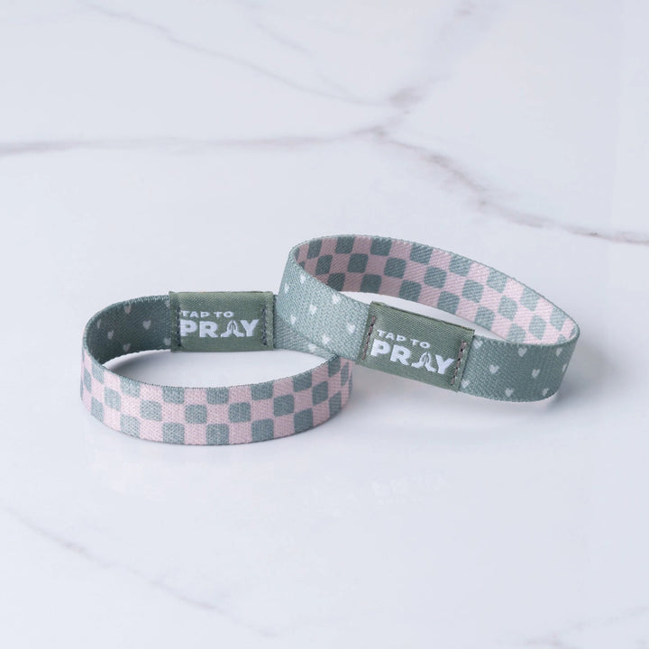 Two checkered wristbands with &