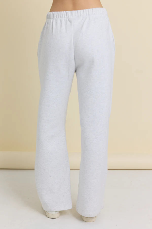 Light gray sweatpants on a beige background