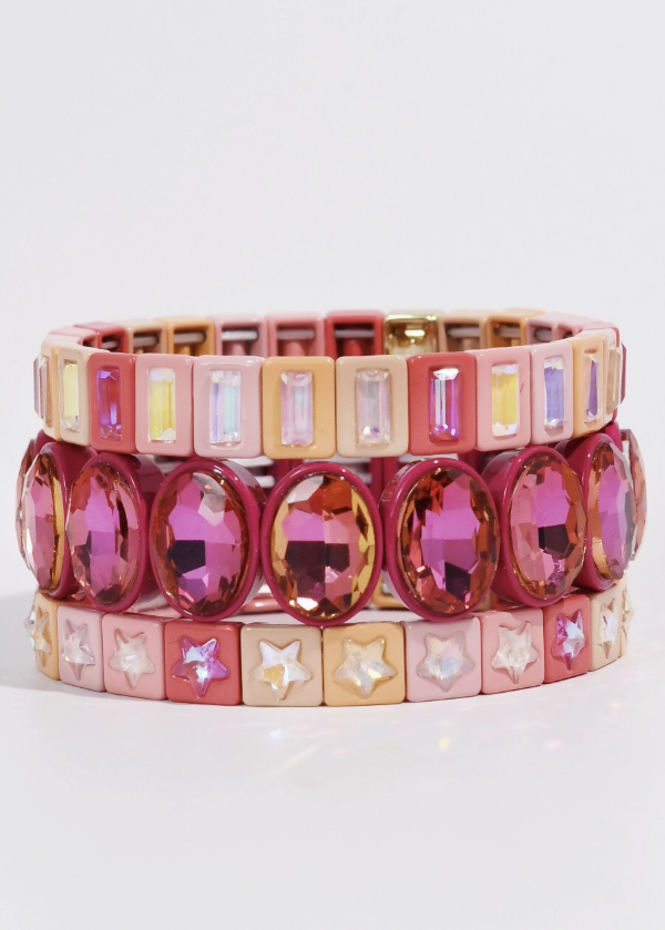 Bracelet Stack including three pink tone stretch bracelets shown on a white background