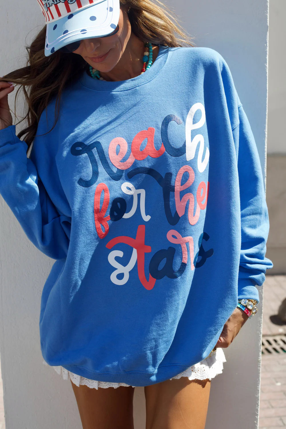 Person wearing a blue sweatshirt with &