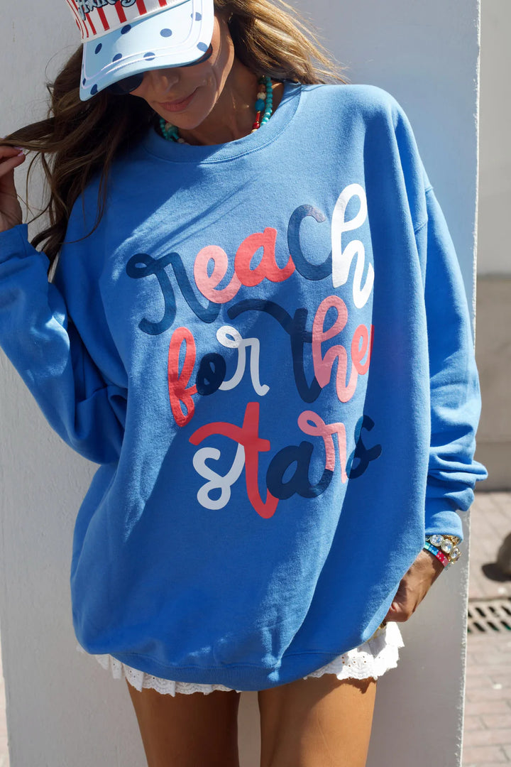 Person wearing a blue sweatshirt with &