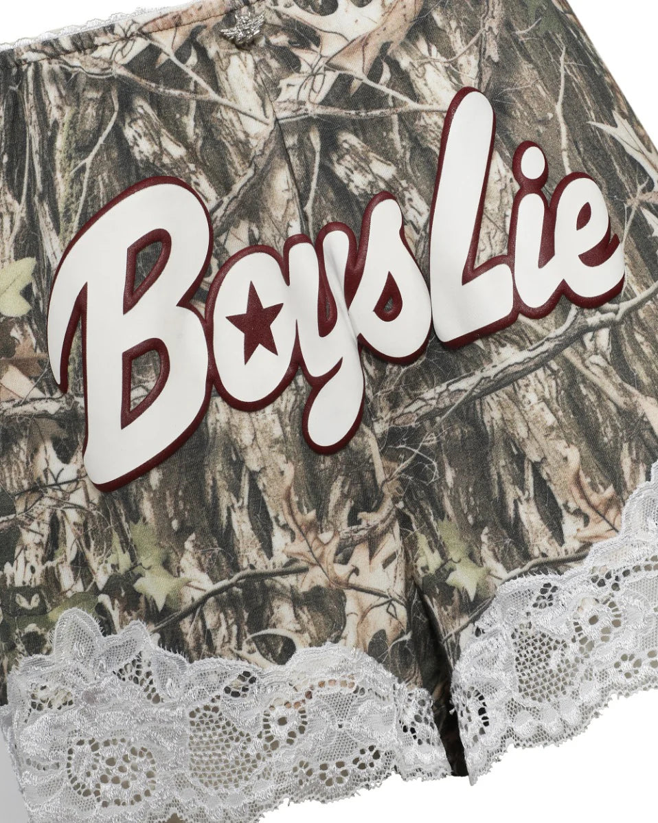 Close up of camo shorts with lace trim saying BOYS LIE