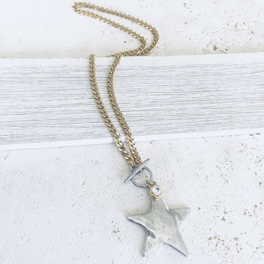 Silver &amp; gold necklace with star and diamond pendant on white background