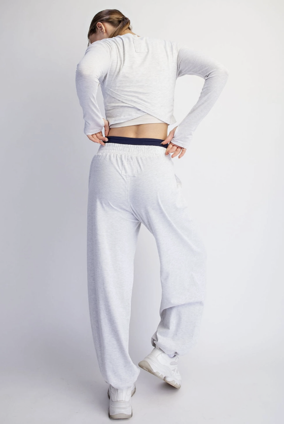 Woman shown from back wearing matching light heather grey lounge set on plain background