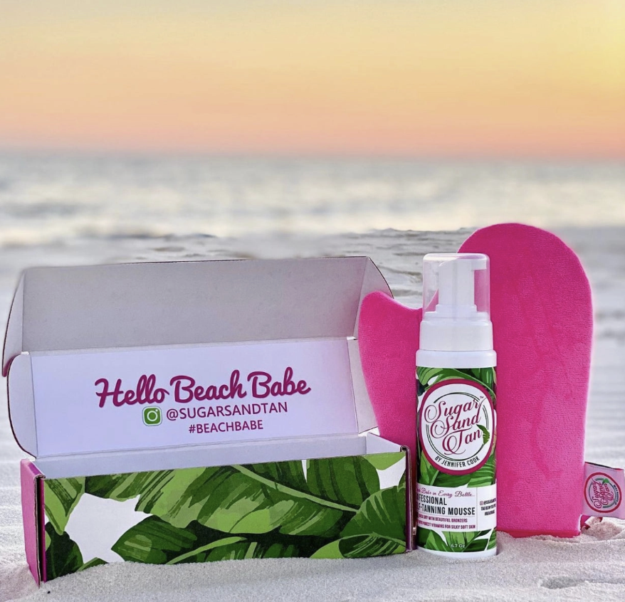 Self tanning product displayed in packaging on beach
