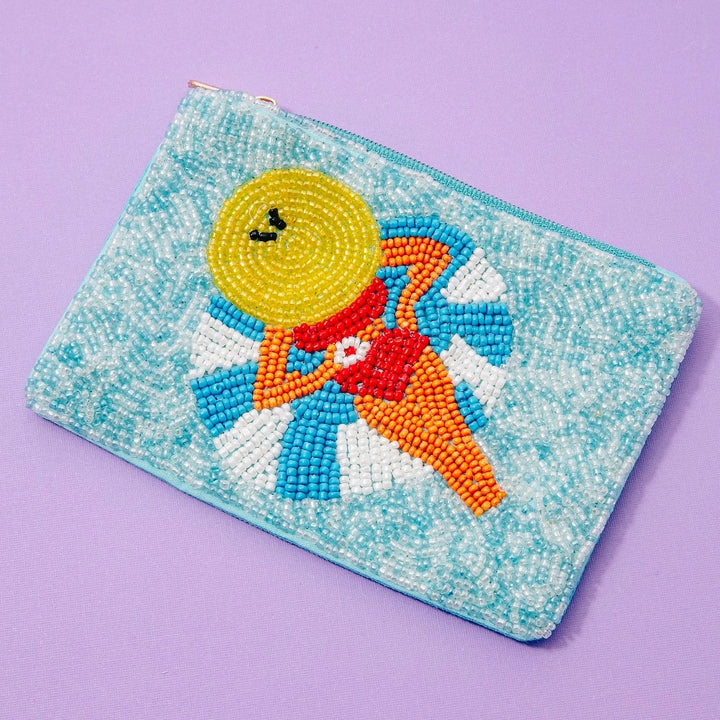 Pouch with a beaded design of a sun character on a purple background