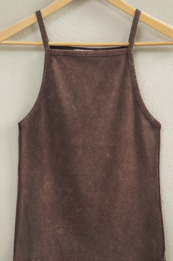 Brown tank top hanging on a wooden hanger against a light gray wall.