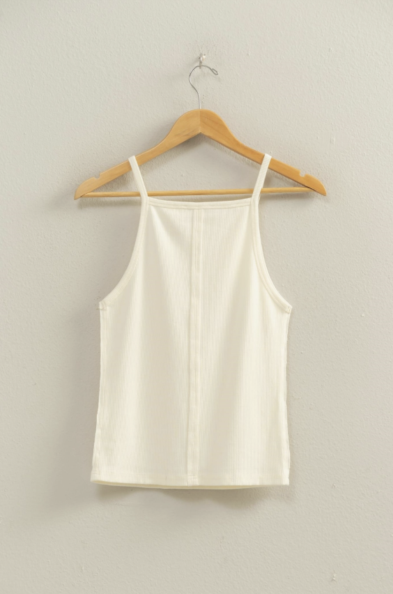 White tank top on a wooden hanger against a plain background