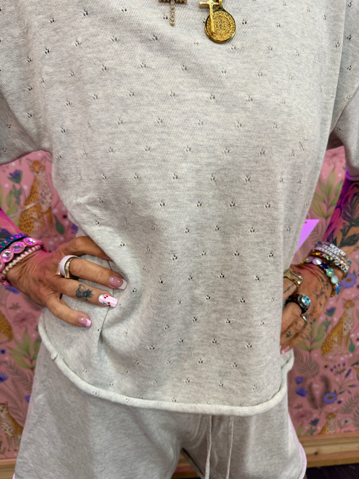 Close up of heather grey pointelle fabric