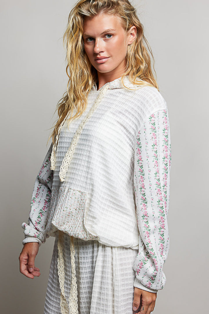 woman wearing white waffle knit hoodie on plain background