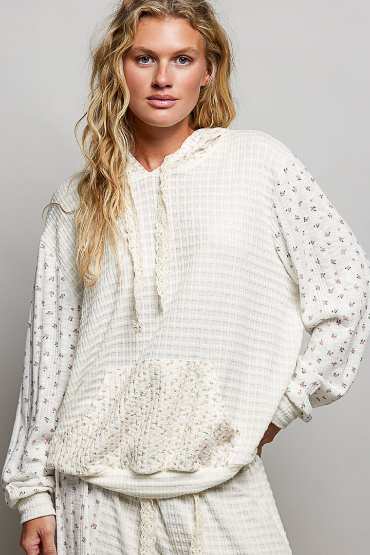 Woman wearing a white textured top with a plain background