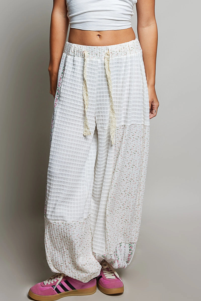 person wearing white waffle knit pants on plain background