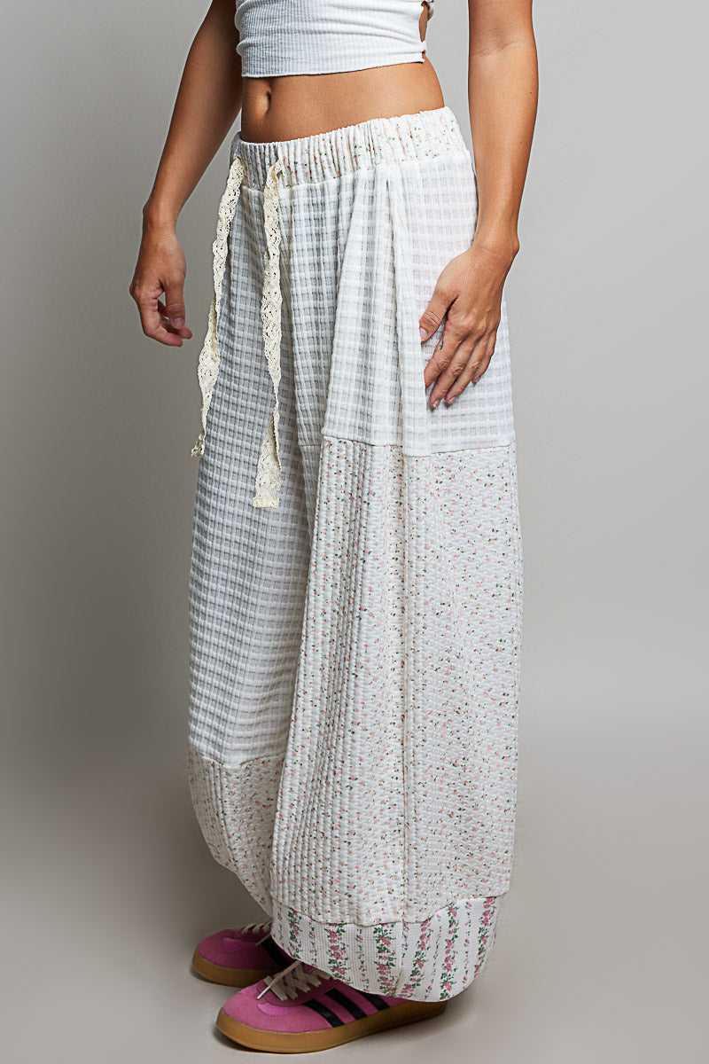 person wearing white waffle knit pants on plain background