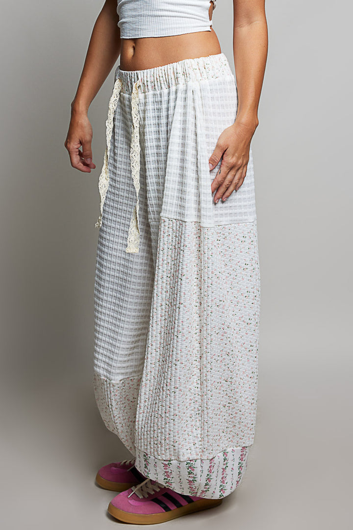 person wearing white waffle knit pants on plain background