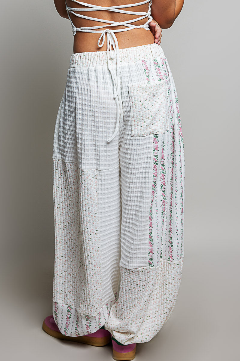 back of person wearing white waffle knit pants on plain background