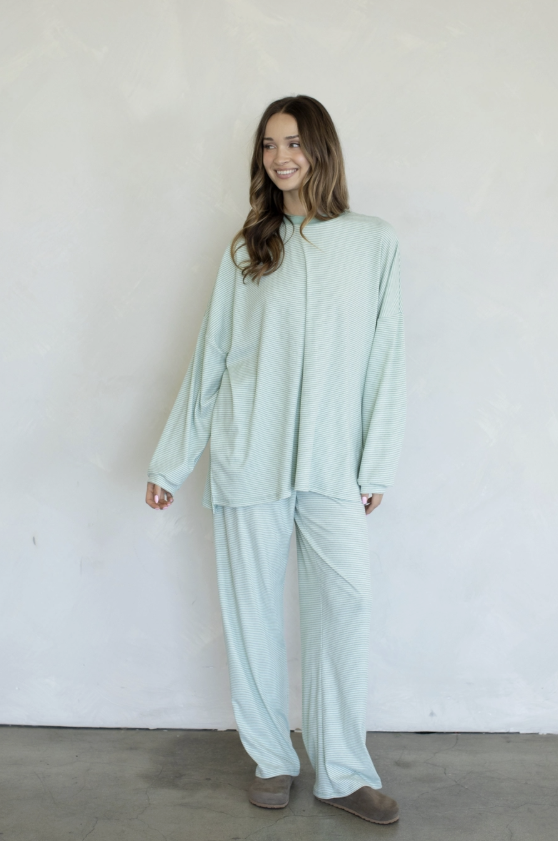 Woman wearing green matching set on plain background