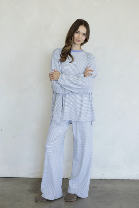 Woman wearing matching set on plain background