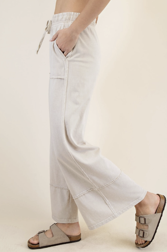 Light-colored wide-leg pants worn by a person on a plain background