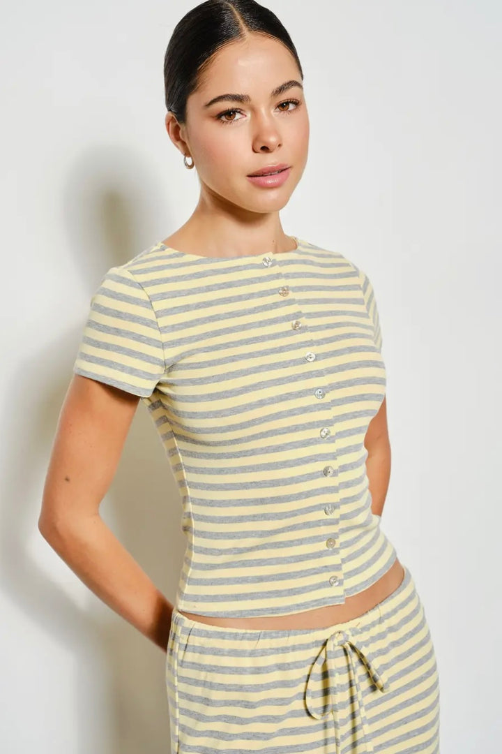 Woman wearing a yellow and gray striped outfit on a white background