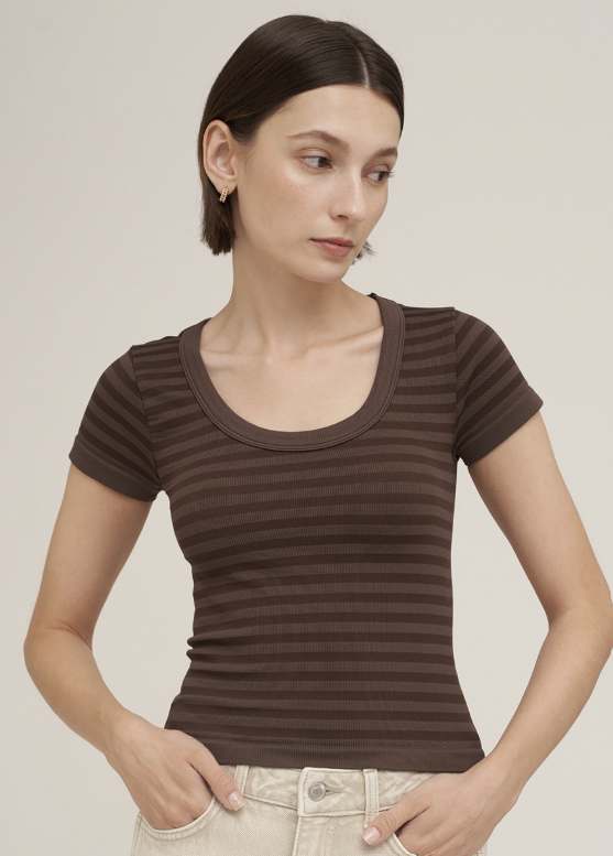 Woman wearing brown striped scoop neck shirt on white background