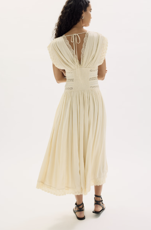 Woman wearing beige dress on white background