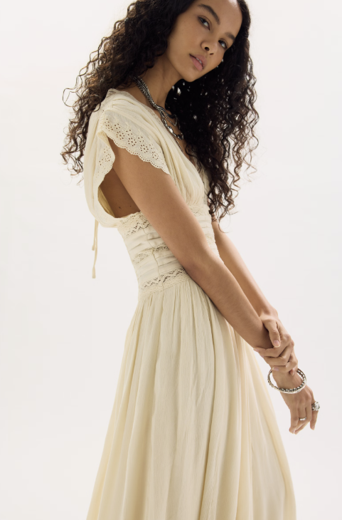 Woman wearing beige dress on white background