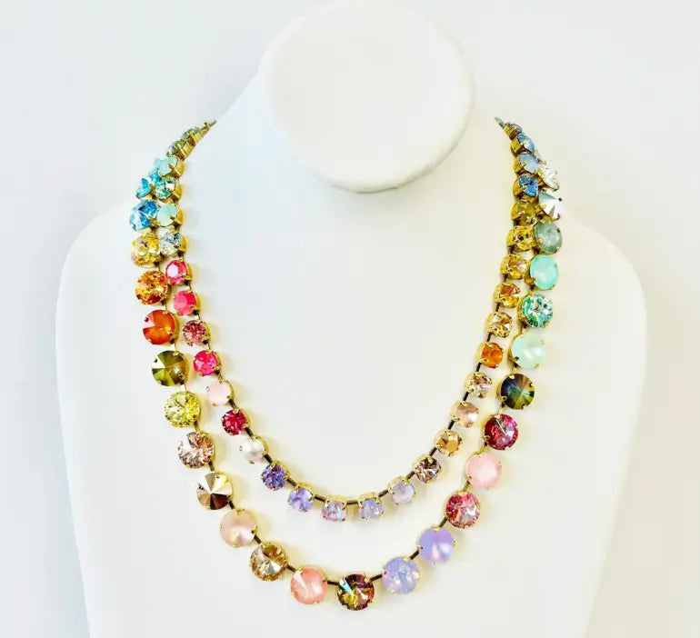 Crystal necklace in multicolor on bust on plain background