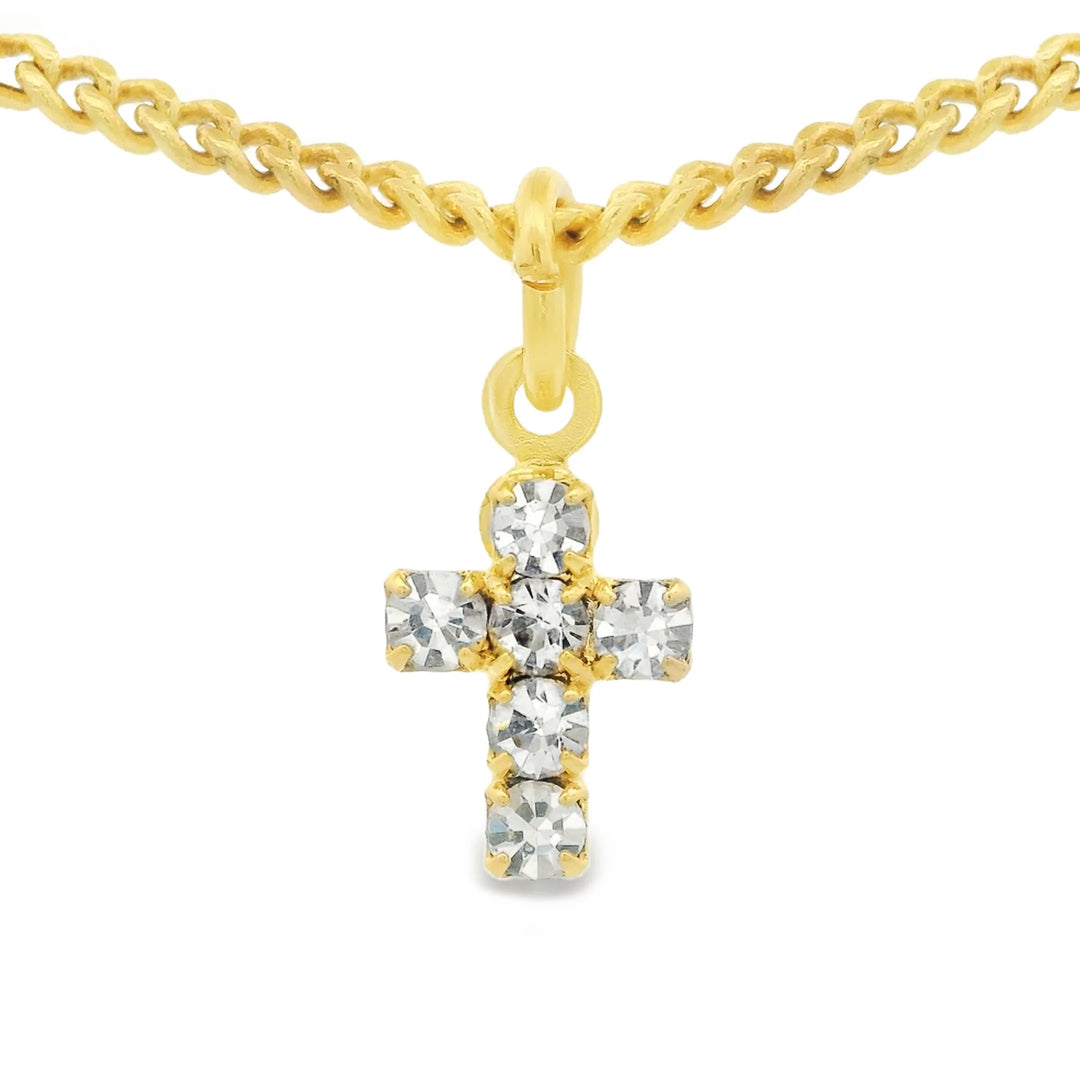 Single clear cross on gold chain on white background