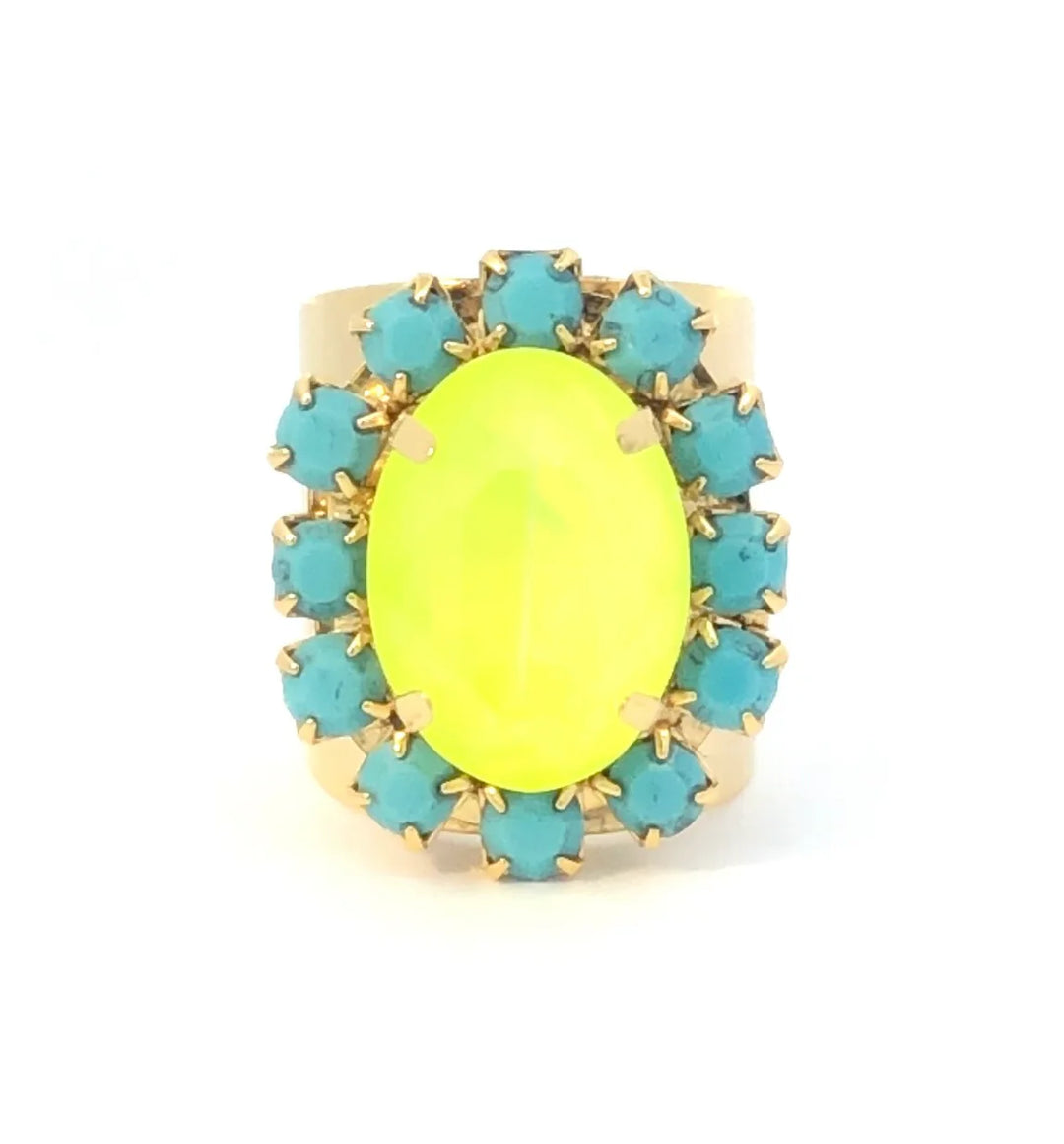 Ring with a yellow oval stone and turquoise gemstones on a white background