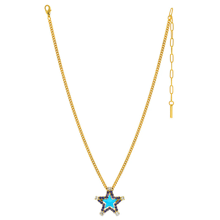 A gold chain necklace featuring a star-shaped pendant with a bright blue center, bordered by small dark stones and clear rhinestones, shown against a plain white background.