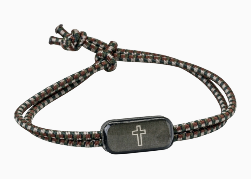 Cord bracelet in green and browns with black cross on white background