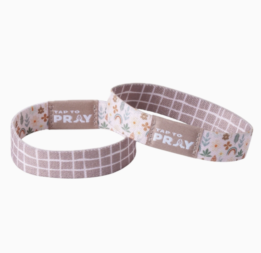 Two tap to pray bracelets showing the reversible sides on white background