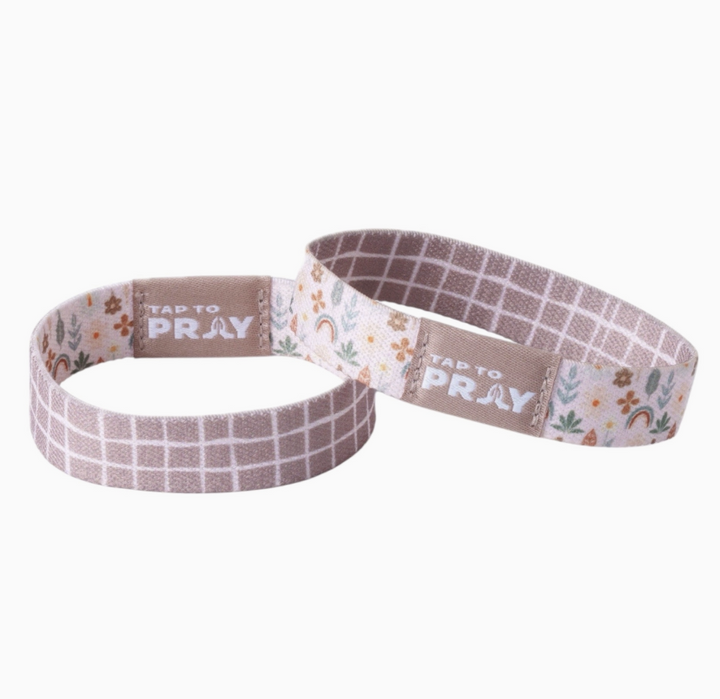 Two tap to pray bracelets showing the reversible sides on white background