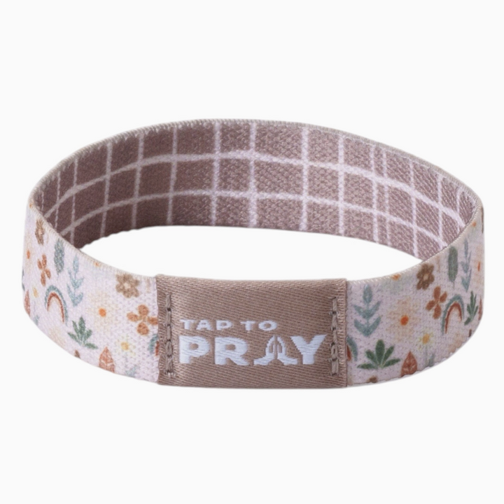 Tap to pray bracelet with symbols and plaid on plain background