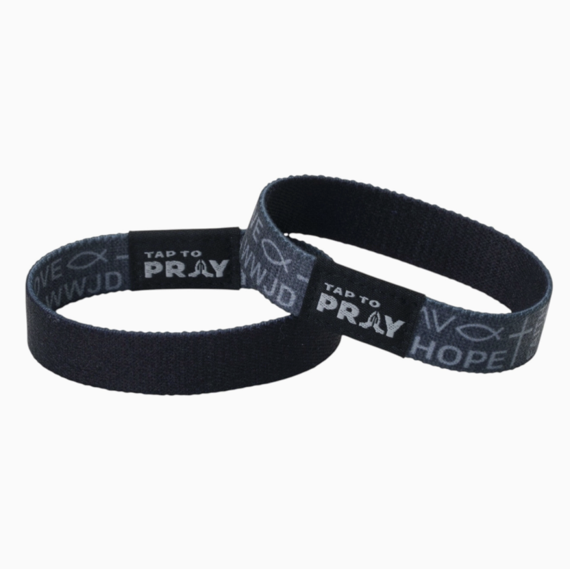 Two tap to pray bracelets featuring one side of black and one side of symbols of faith on white background