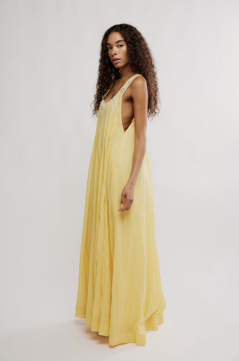 Woman wearing a yellow dress on a white background