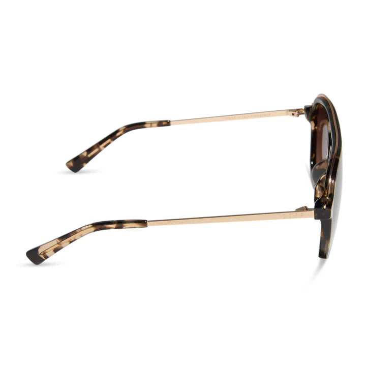 Sunglasses with tortoiseshell frame and gold accents on a white background