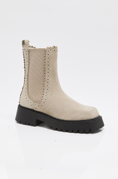 Tan suede boots with chunky black sole on white background