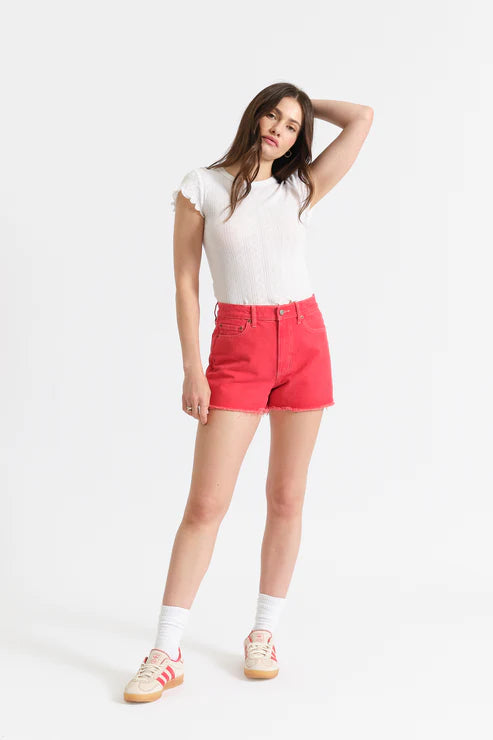 Woman wearing a white t-shirt and red shorts on a white background