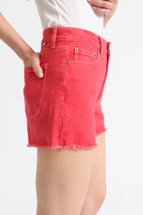 Red denim shorts worn by a person on a white background