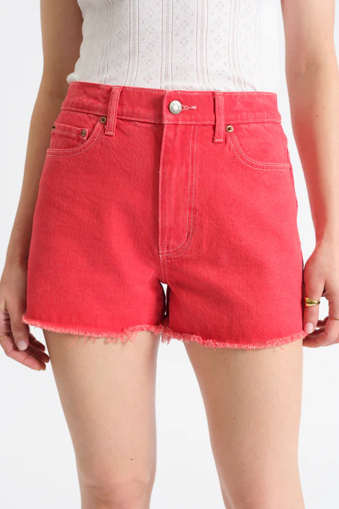 Red denim shorts worn by a person on a white background