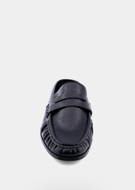 A single black leather loafer with a decorative strap across the vamp, photographed from a front-facing angle on a light gray background.