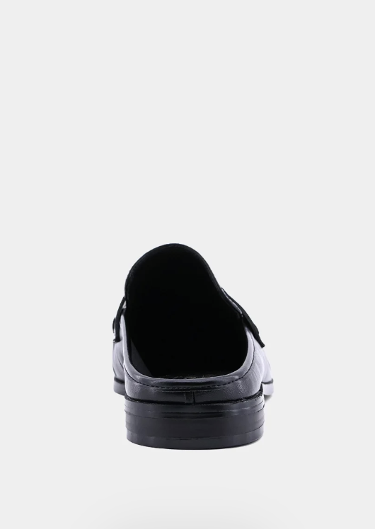 A single black leather loafer shown from the back against a plain white background.