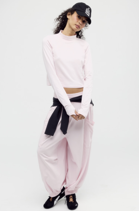 Woman wearing matching pink set on white background