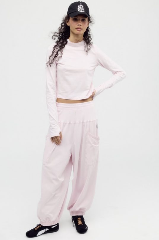 Woman wearing pink matching set on white background