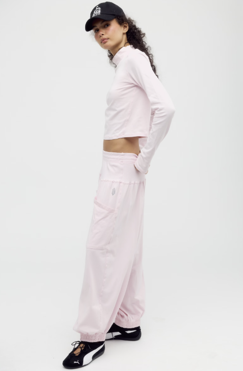Woman wearing pink matching set on white background